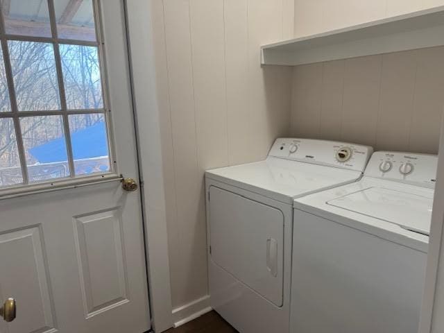 laundry area with separate washer and dryer and a wealth of natural light