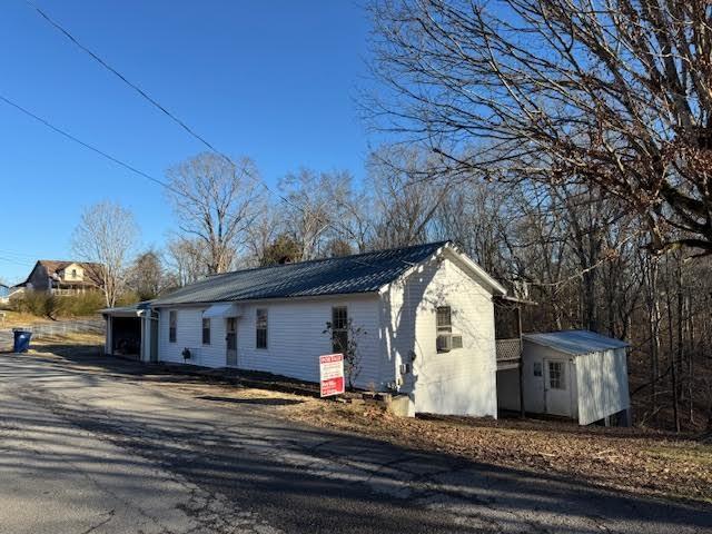 view of home's exterior featuring a storage unit