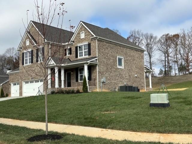 view of front of home featuring a garage, a front yard, and covered porch