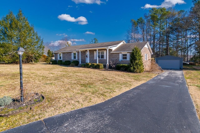 ranch-style house with a garage, an outbuilding, and a front yard