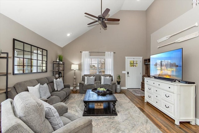 living room featuring ceiling fan, dark hardwood / wood-style floors, and high vaulted ceiling