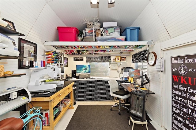 office featuring vaulted ceiling and wood walls