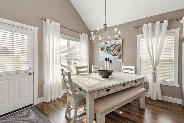 dining space with vaulted ceiling, dark wood-type flooring, and an inviting chandelier