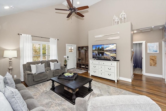 living room featuring wood-type flooring, ceiling fan, and high vaulted ceiling