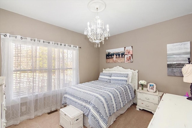 bedroom with carpet flooring and a chandelier