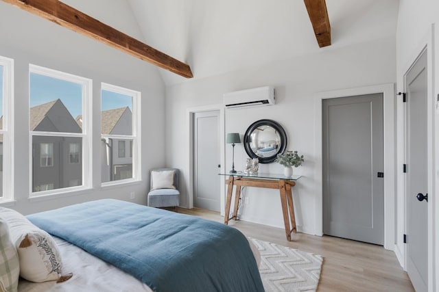 bedroom with lofted ceiling with beams, a wall unit AC, and light hardwood / wood-style floors