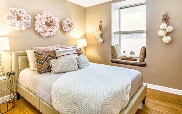 bedroom with hardwood / wood-style floors