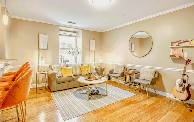 living room featuring ornamental molding and light wood-type flooring