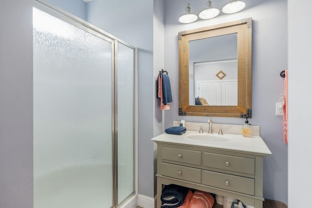 bathroom with vanity and a shower with door