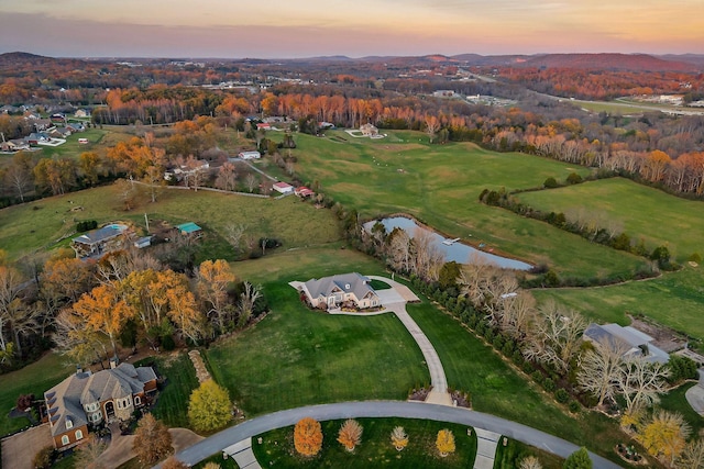 aerial view at dusk with a water view