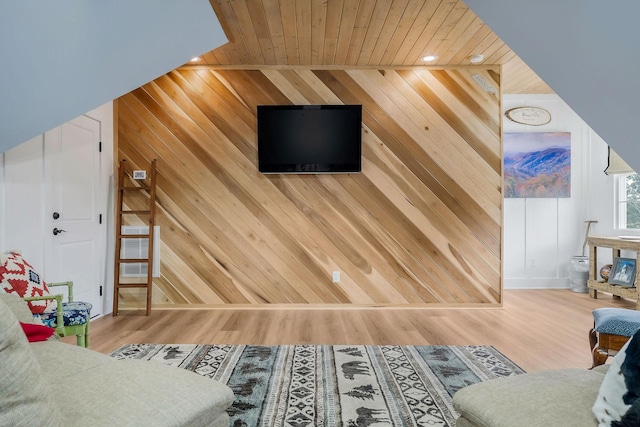 living room with hardwood / wood-style flooring, wooden ceiling, and wooden walls