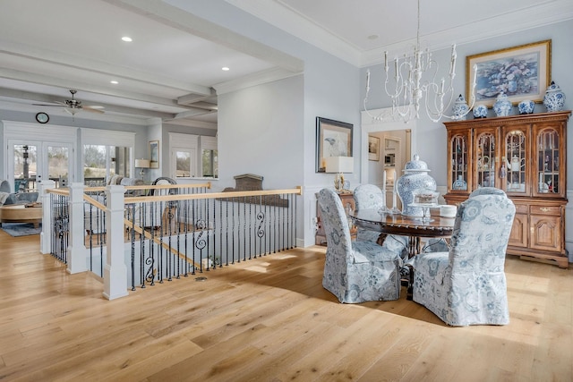 dining space with beamed ceiling, ornamental molding, light hardwood / wood-style floors, and an inviting chandelier