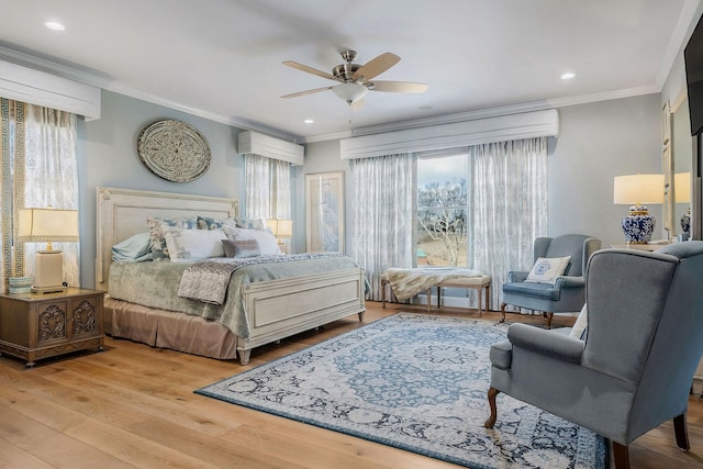 bedroom featuring light hardwood / wood-style flooring, ornamental molding, and ceiling fan