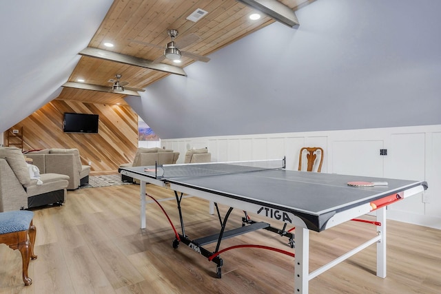 recreation room with wooden ceiling, light hardwood / wood-style floors, and vaulted ceiling with beams