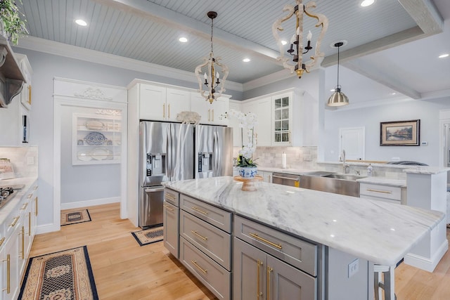 kitchen with pendant lighting, white cabinetry, a center island, and beamed ceiling