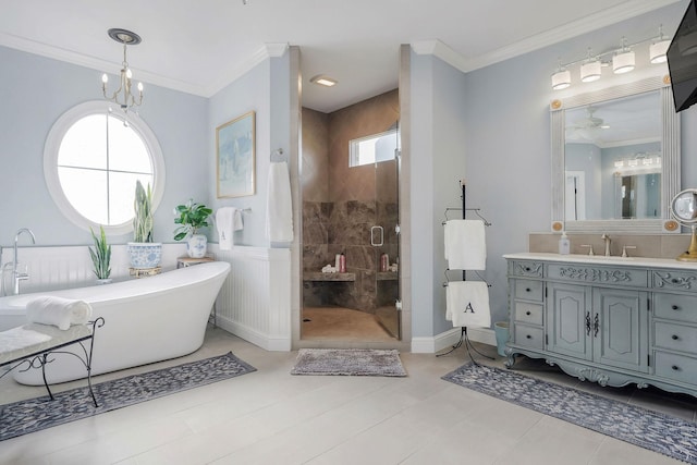 bathroom with vanity, an inviting chandelier, crown molding, and plus walk in shower