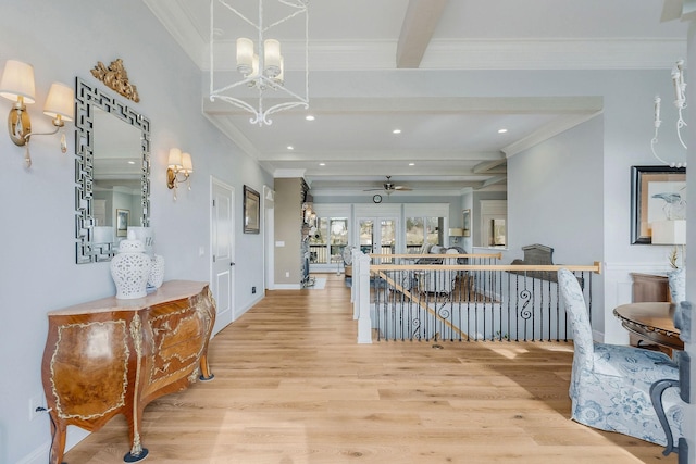 corridor featuring beamed ceiling, crown molding, a chandelier, and light hardwood / wood-style flooring