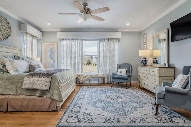 bedroom featuring crown molding, ceiling fan, and light hardwood / wood-style floors