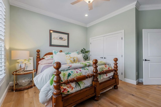 bedroom featuring crown molding, a closet, ceiling fan, and light wood-type flooring