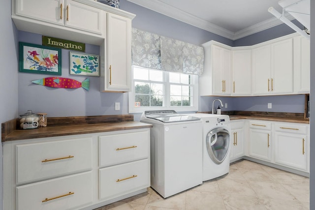 laundry area featuring sink, light tile patterned floors, washer and clothes dryer, cabinets, and ornamental molding