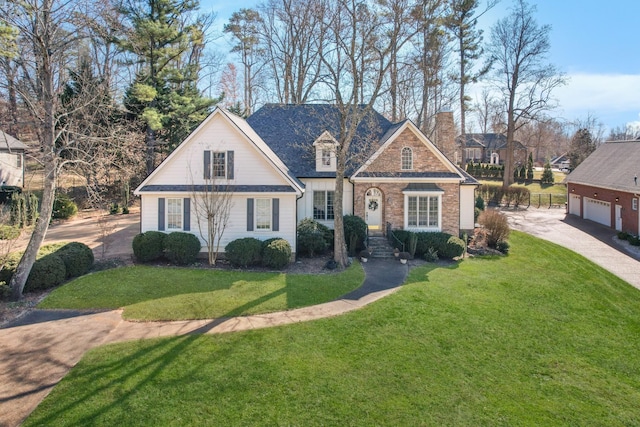 view of front of house with a garage and a front lawn