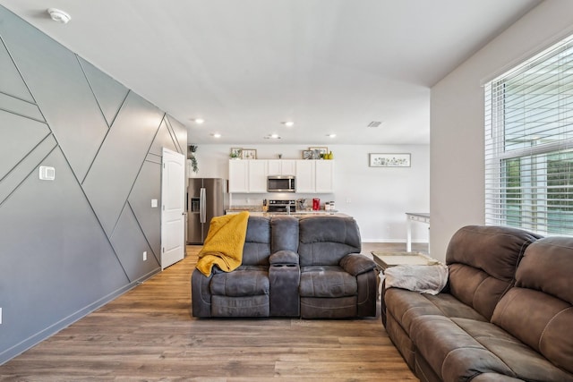 living room featuring light hardwood / wood-style flooring and a wealth of natural light