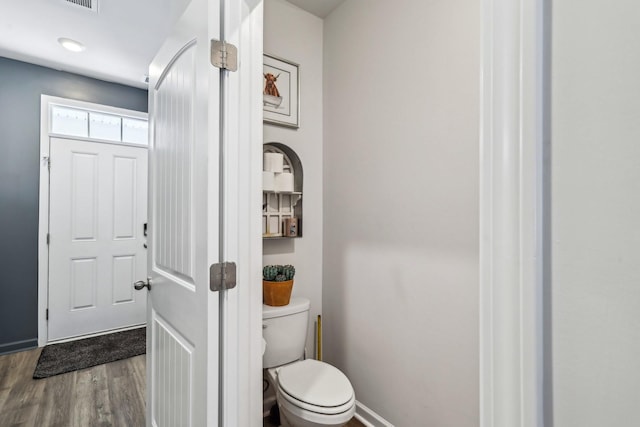 bathroom with hardwood / wood-style flooring and toilet