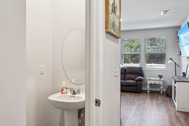 bathroom with hardwood / wood-style flooring