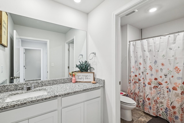 bathroom featuring vanity and toilet