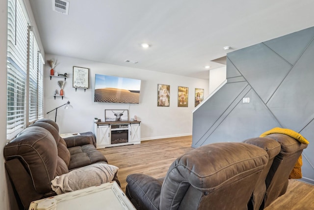 living room with a healthy amount of sunlight and light hardwood / wood-style flooring