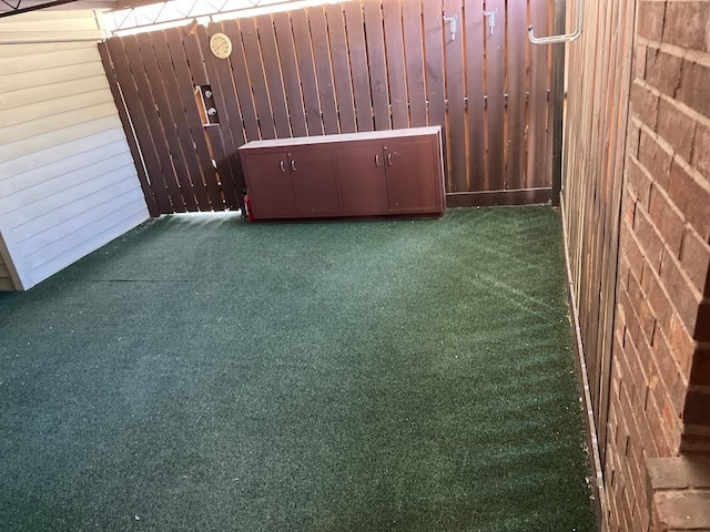 spare room with dark carpet