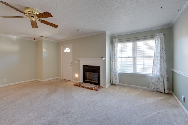 unfurnished living room featuring crown molding, light colored carpet, ceiling fan, and a textured ceiling