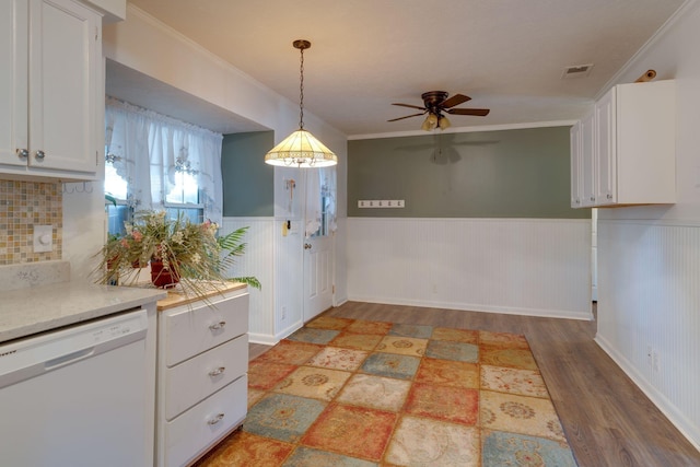 kitchen with pendant lighting, white cabinets, ceiling fan, white dishwasher, and crown molding