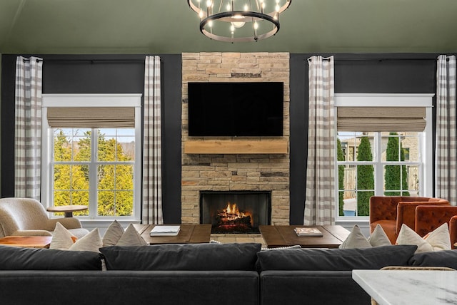 living room with a notable chandelier and a fireplace