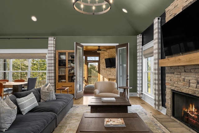 living room featuring lofted ceiling, a fireplace, and plenty of natural light