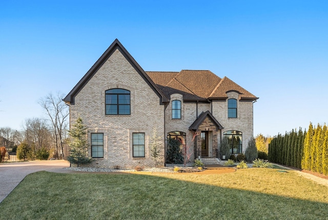 french country style house with a front lawn