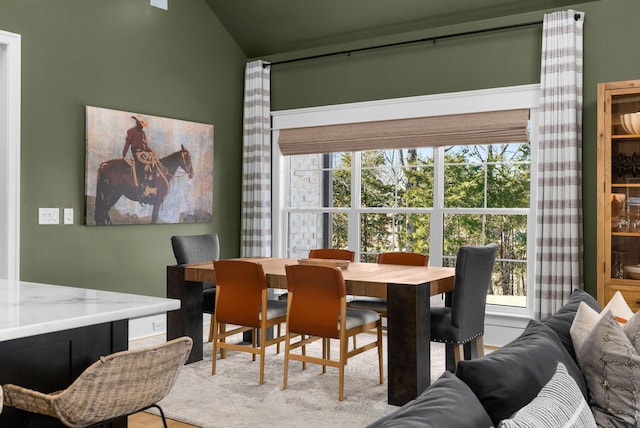 dining area featuring lofted ceiling