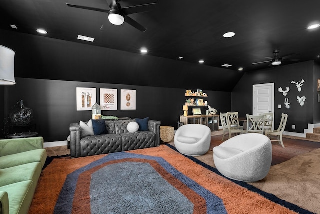 home theater room with vaulted ceiling, carpet flooring, and ceiling fan