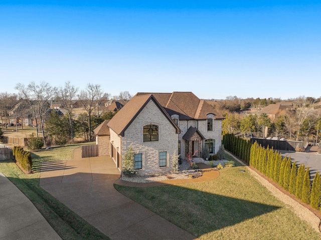 view of front of property featuring a garage and a front yard