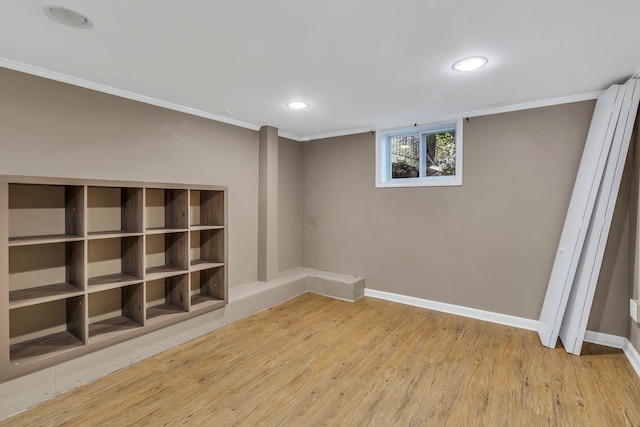 basement with hardwood / wood-style floors and crown molding