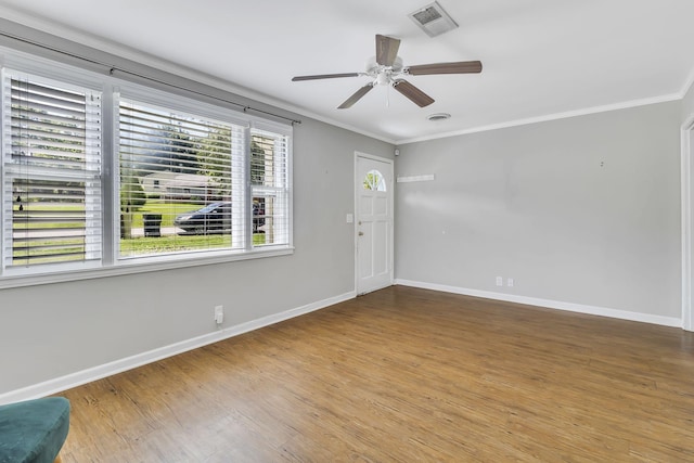 spare room featuring ornamental molding, hardwood / wood-style floors, and ceiling fan