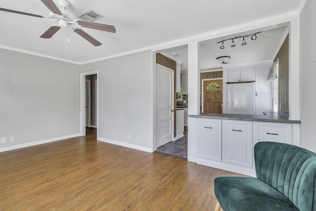 interior space featuring white cabinetry, light wood-type flooring, ornamental molding, white fridge, and ceiling fan