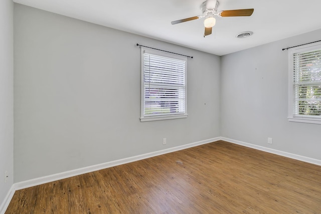 spare room with hardwood / wood-style floors and ceiling fan