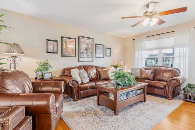 living room with light hardwood / wood-style flooring and ceiling fan