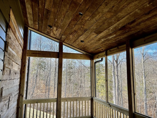 unfurnished sunroom with lofted ceiling and wooden ceiling