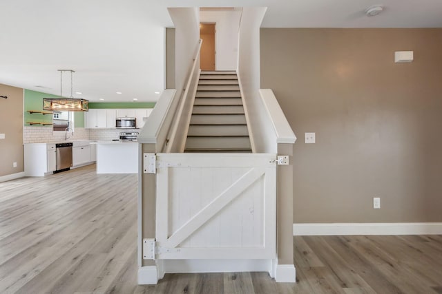 stairway featuring hardwood / wood-style floors