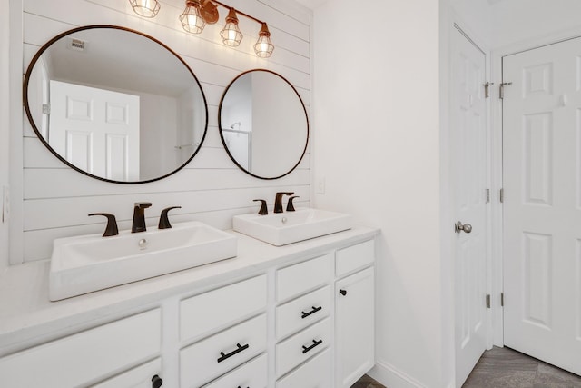 bathroom with vanity and wood walls