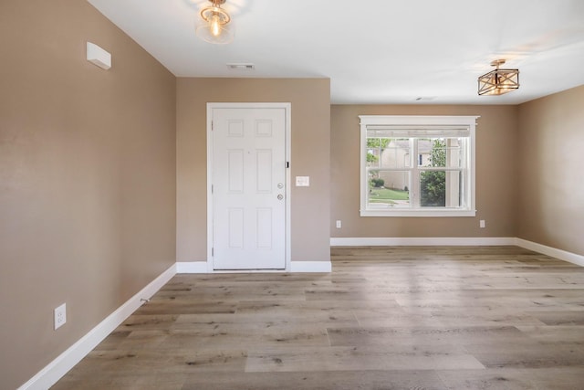 foyer entrance with light wood-type flooring