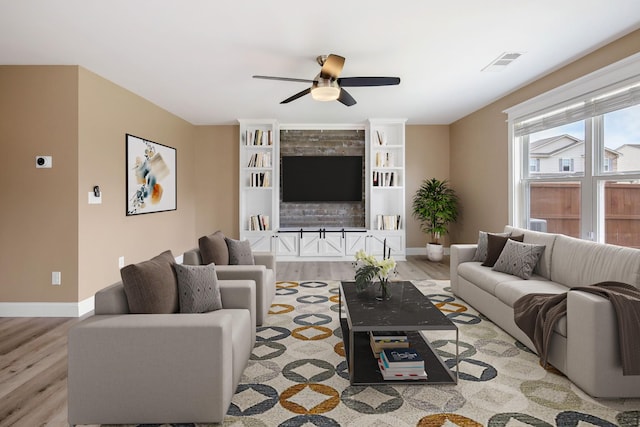 living room featuring ceiling fan and light hardwood / wood-style floors