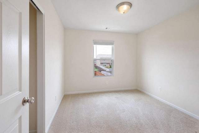 unfurnished room with light colored carpet